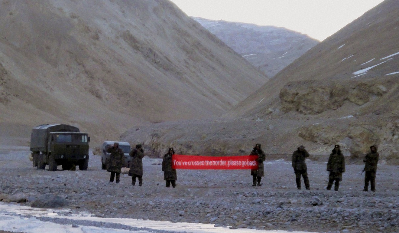 Chinese troops hold a banner that reads ‘You’ve crossed the border, please go back’, in Ladakh. Photo: AP