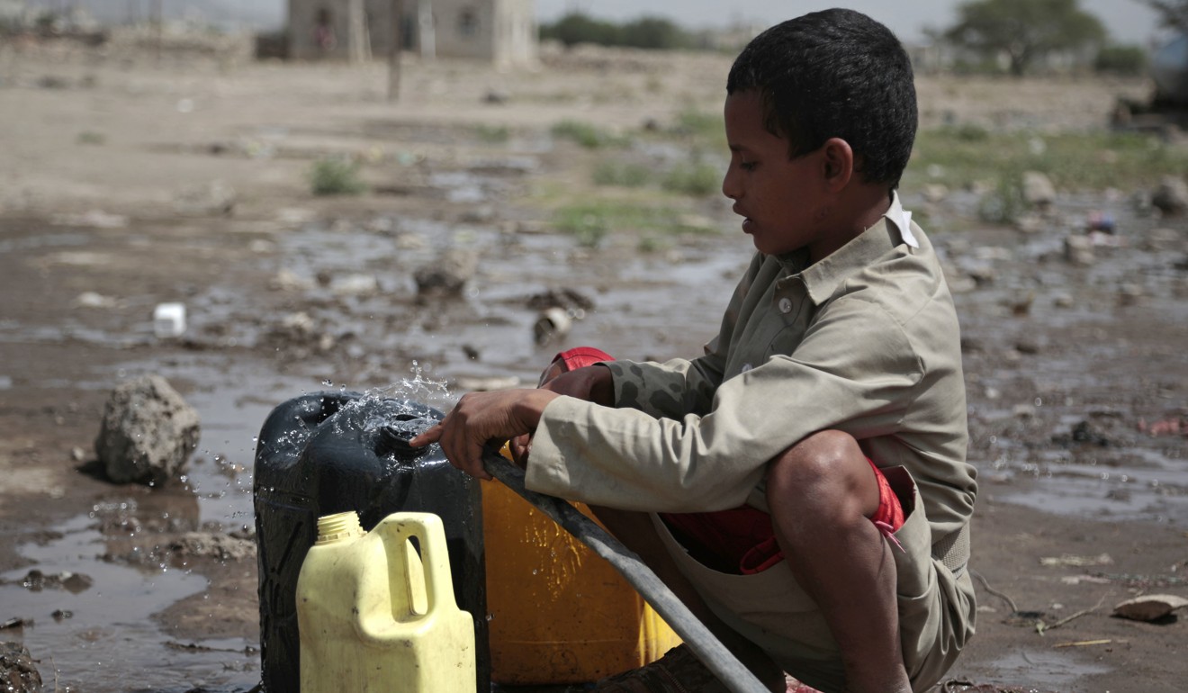 A boy fills a container with water from a well that is allegedly contaminated with cholera bacteria, on the outskirts of Sanaa, Yemen. Photo: AP