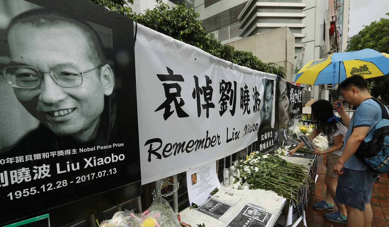 Bouquets of flowers were placed outside the Chinese government's Liaison Office in Western District in honour of Liu Xiaobo. Photo: Edward Wong