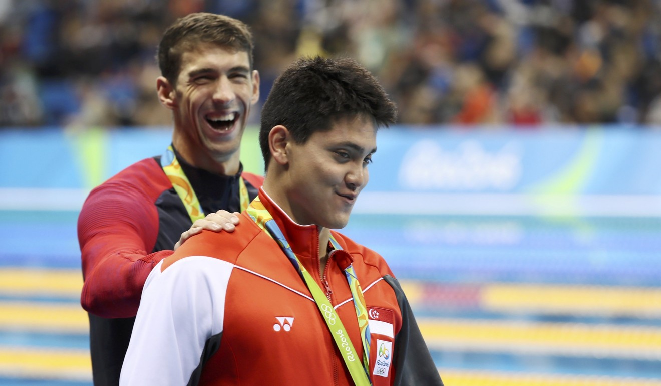 Joseph Schooling is congratulated by Michael Phelps. Photo: Reuters