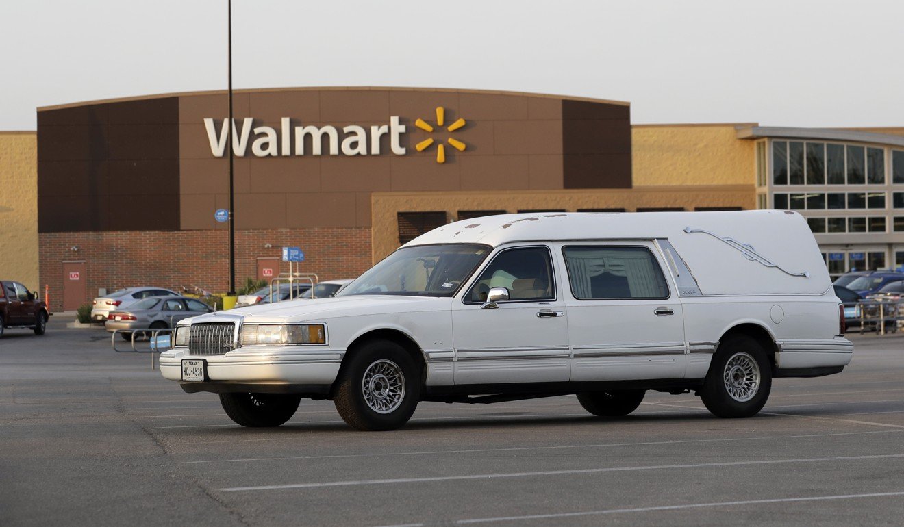 A hearse sits in the parking lot of a Walmart store where nine peopledied in a semi-trailer loaded with at least 30 others outside in stifling summer heat in San Antonio. Photo: AP