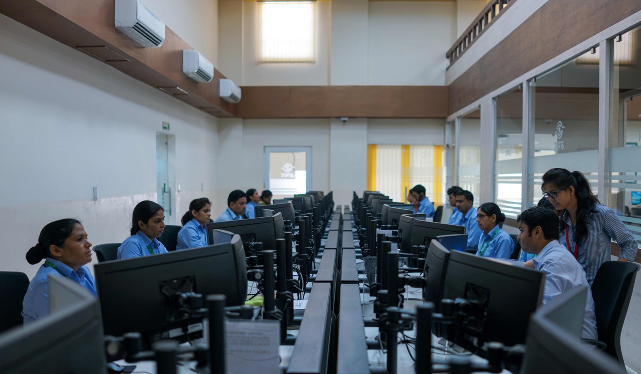 Indian police officials work inside the police command centre at Jaipur Commissionate Headquarters. Photo: AFP