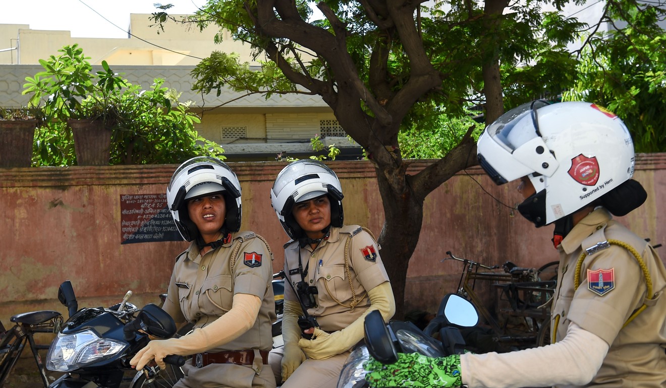 Members of a newly launched female police patrol unit drive through the old city in Jaipur. Photo: AFP