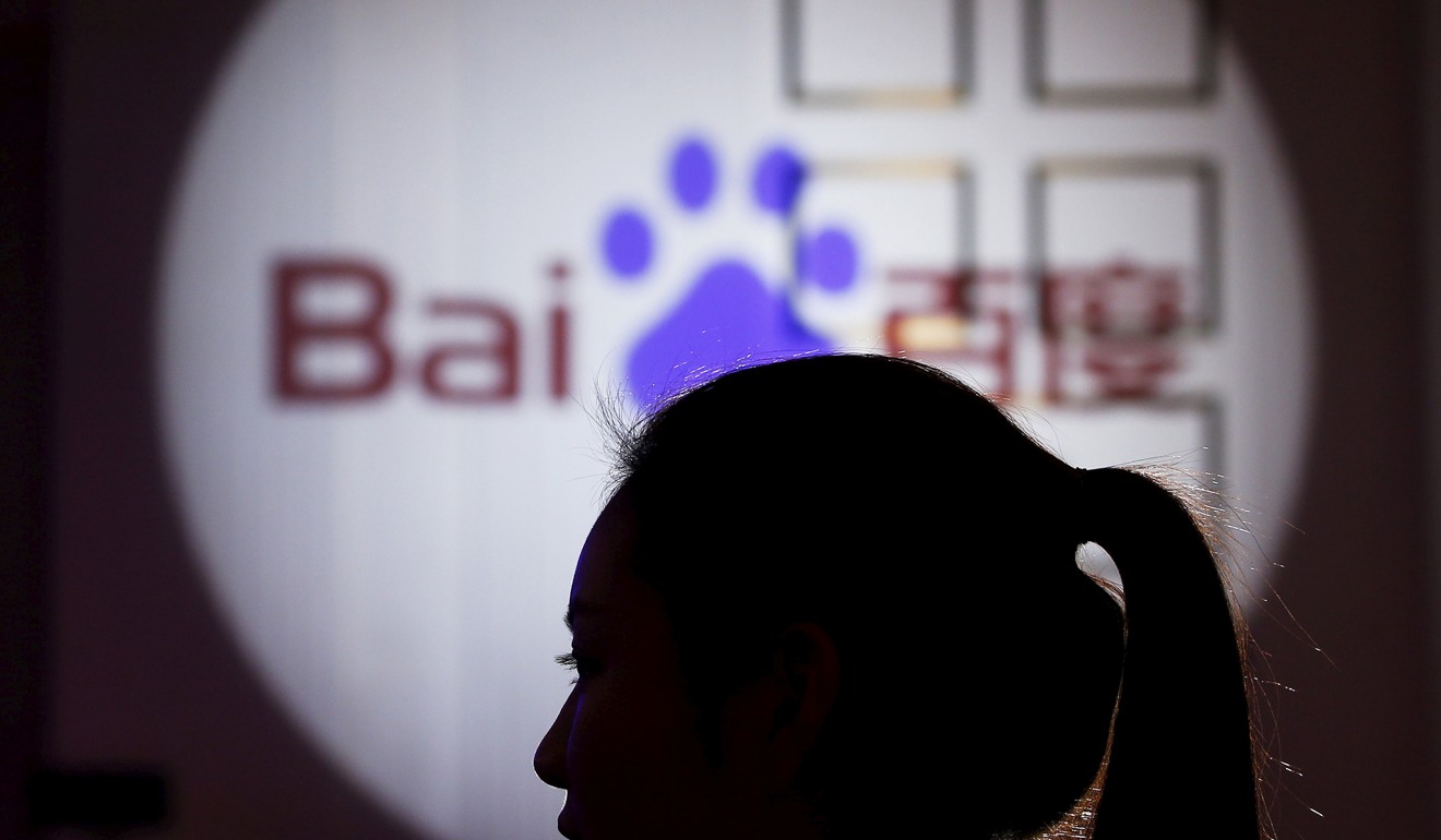 A woman is silhouetted against the Baidu logo at a new product launch in Shanghai, China. Photo: Reuters