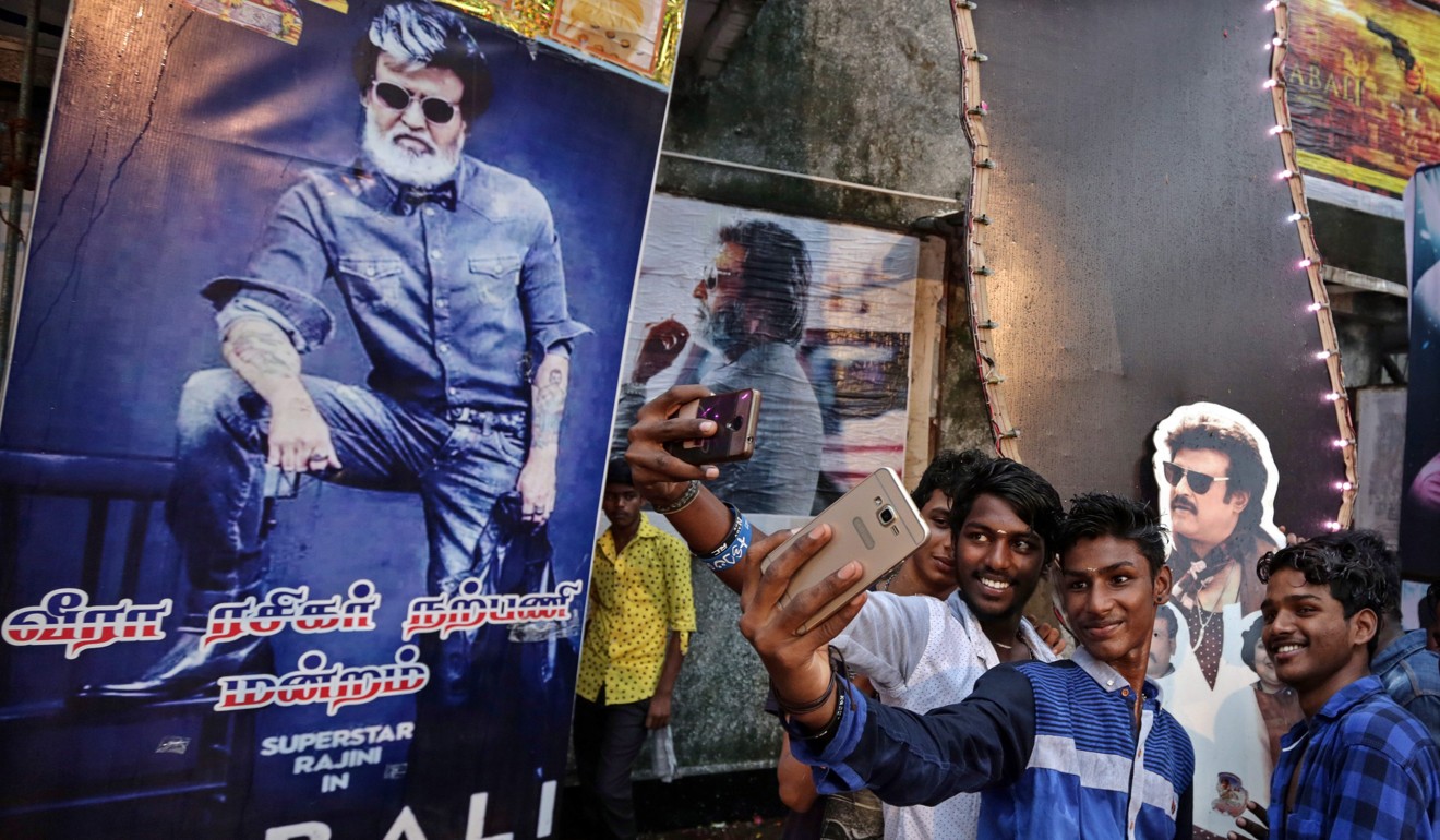 Indian fans of superstar Rajinikanth takes selfie with his posters as they celebrates his much awaited film 'Kabali' at Aurora theatre in Mumbai, India. Photo: EPA