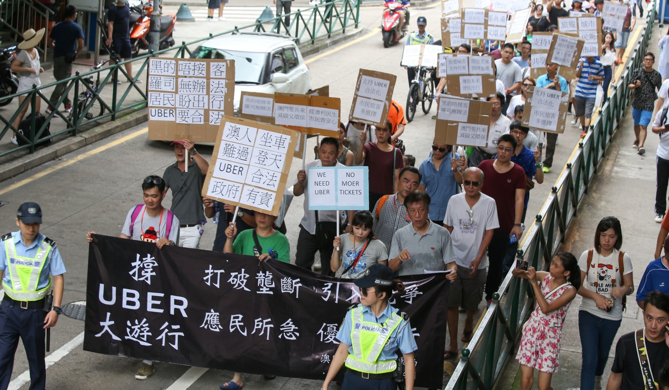 Supporters of Uber march in Macau. The ride-hailing company has temporarily suspended operations in the autonomous region. Photo: Dickson Lee