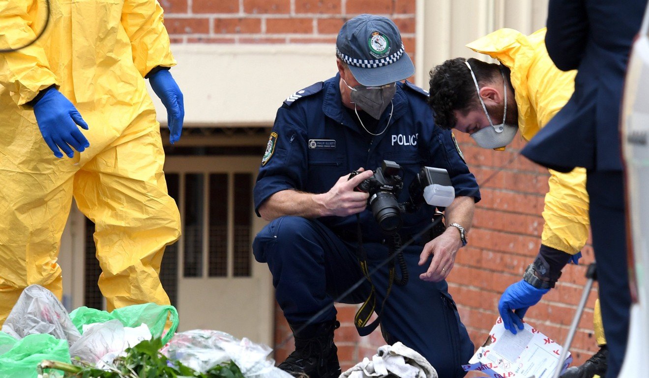 Australian police examine items seized from a property in Sydney. Photo: EPA