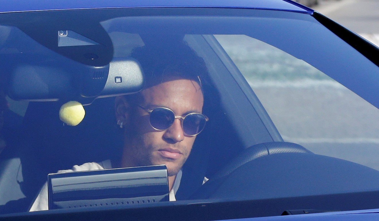 Brazilian soccer player Neymar drives to arrive to Joan Gamper training camp near Barcelona. Photo: Reuters