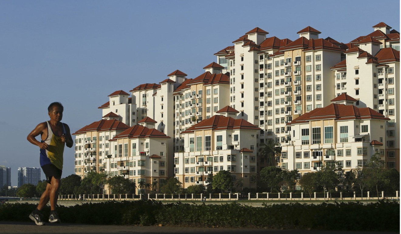 A man jogs past blocks of private condominium at Tanjong Rhu in Singapore. Mainland Chinese are leading a kind of foreign invasion of the property market, buying up developments in the Lion City. Photo: Reuters