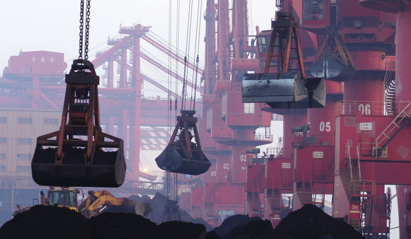 Heavy machines move imported iron ore at the dock in Rizhao in China's Shandong province. Exports from North Korea will now be banned following the UN vote. Photo: AP