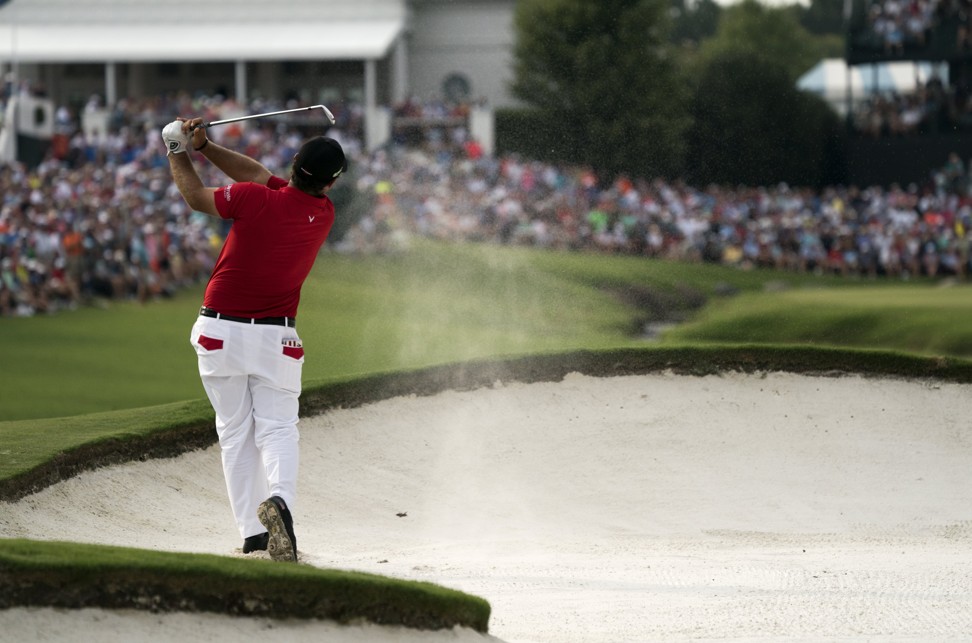 Patrick Reed of the USA hits out of the sand on the eighteenth hole at US PGA Championship. Photo: EPA