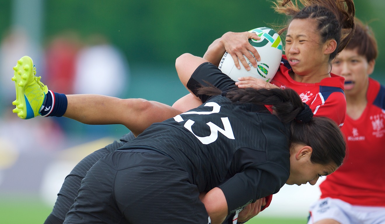 Hong Kong winger Chong Ka-yan is hit hard by her New Zealand opponent. Photo: HKRU