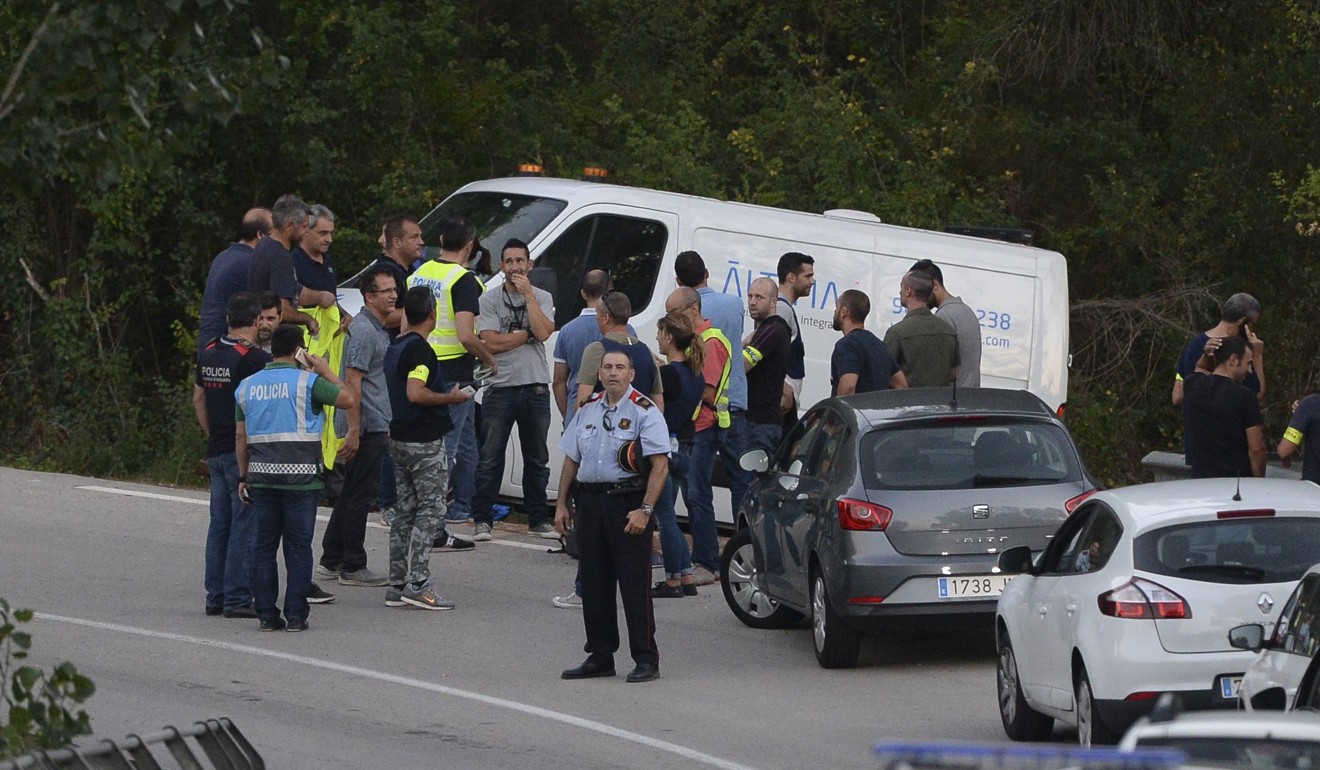 Spanish police stand by an undertaker’s van carrying the body of Younes Abouyaaqoub on the site where he was shot on August Monday in Subira, south of Barcelona. Photo: AFP