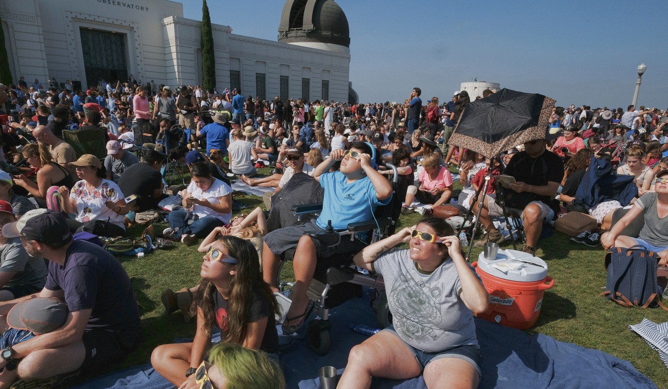 The Tinoco family from Cyprus, California, gather to watch the partial eclipse at the Griffith Observatory in Los Angeles on Monday, August 21, 2017. Photo: AP