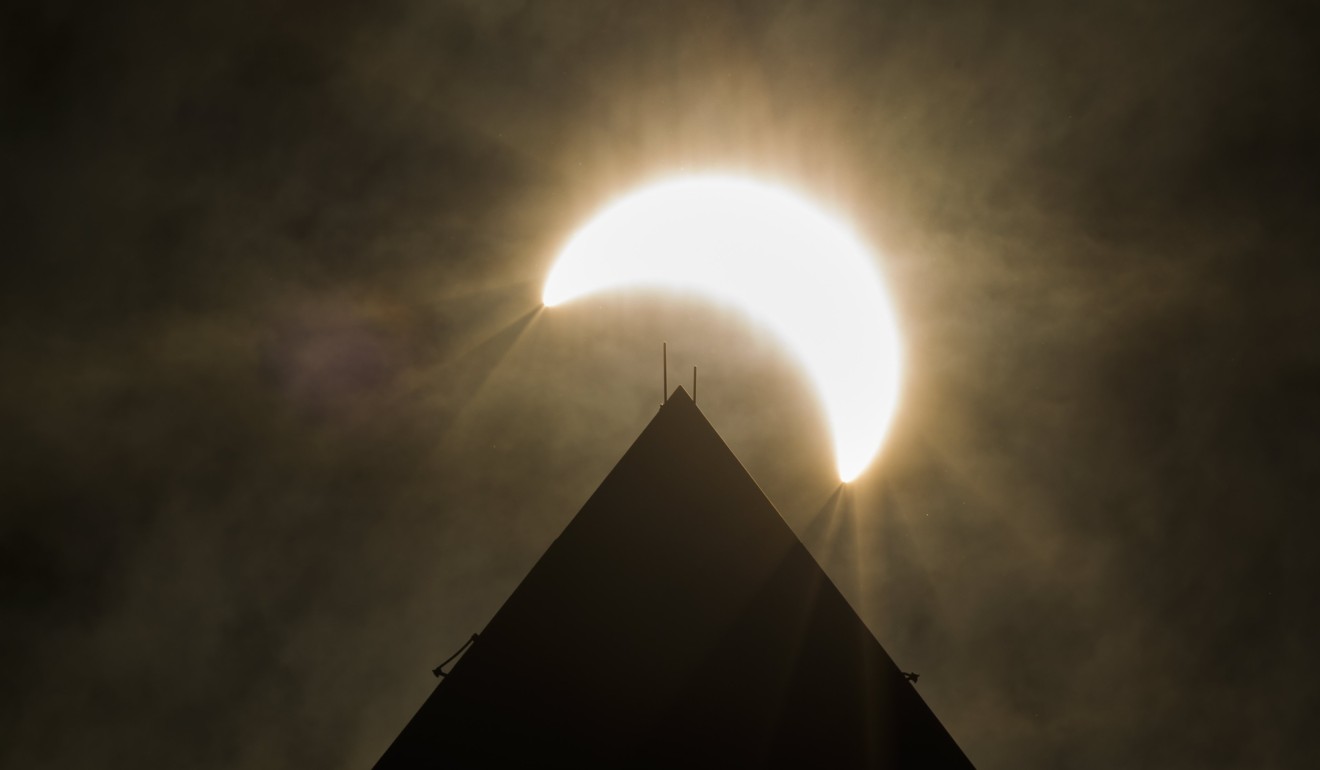 The eclipse above the Washington Monument. Photo: EPA