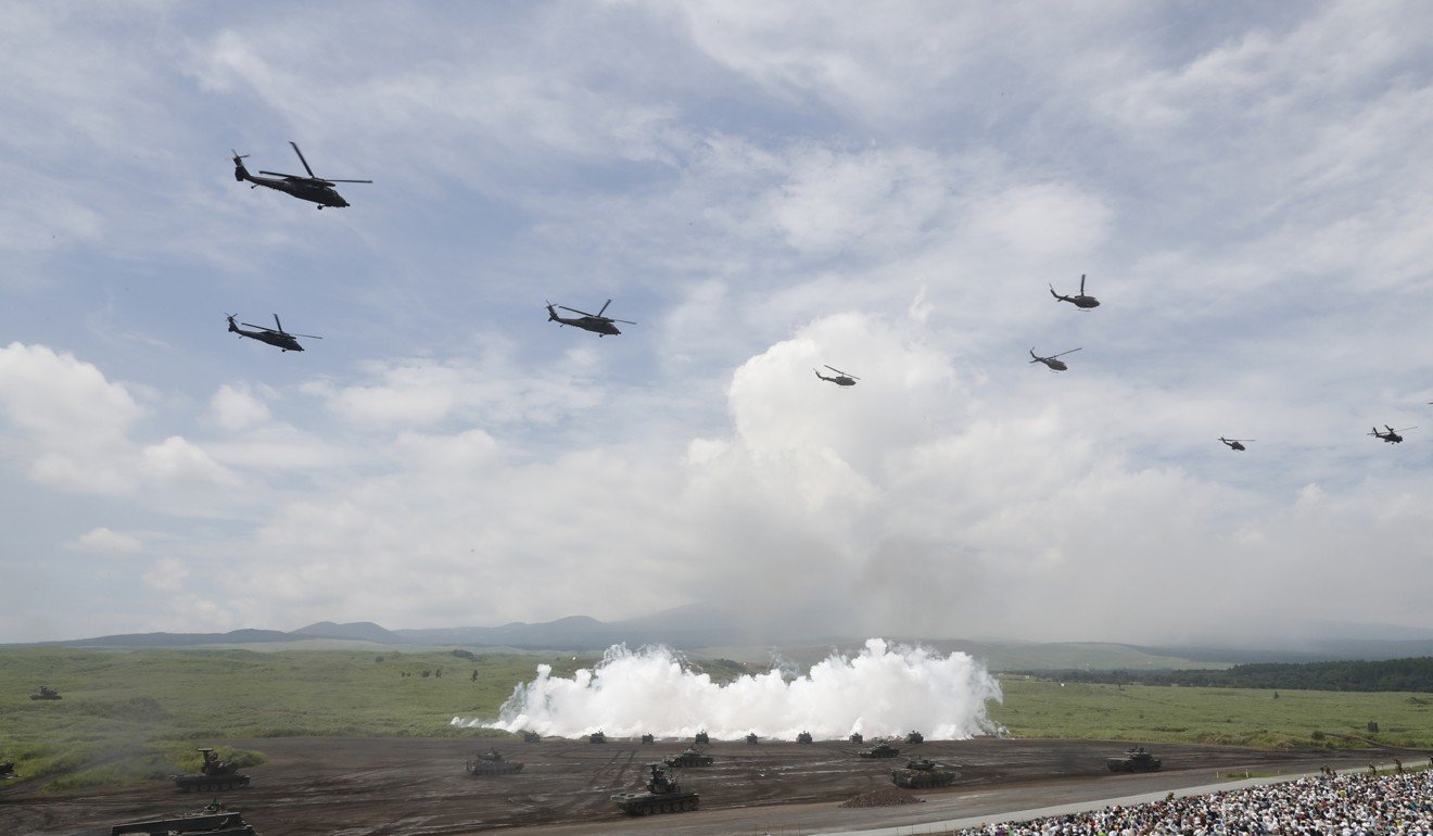 A line tanks release a smoke screen. Photo: AFP