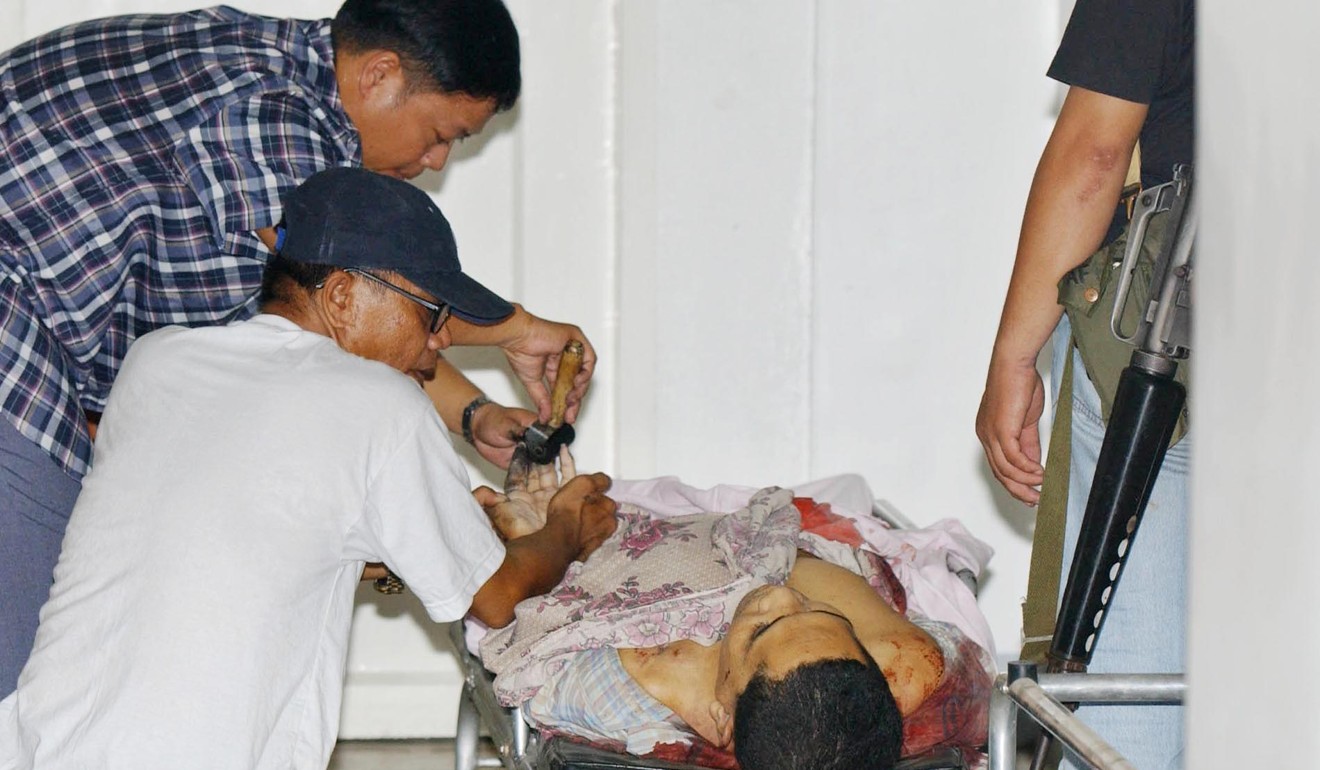 Philippine police inspect the body of Muslim rebel leader Bakal Hapilon, the brother of Isnilon Hapilon. Photo: AFP