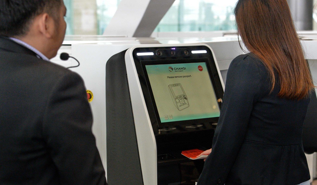 The self-baggage check-in machine being demonstrated. Photo: AFP