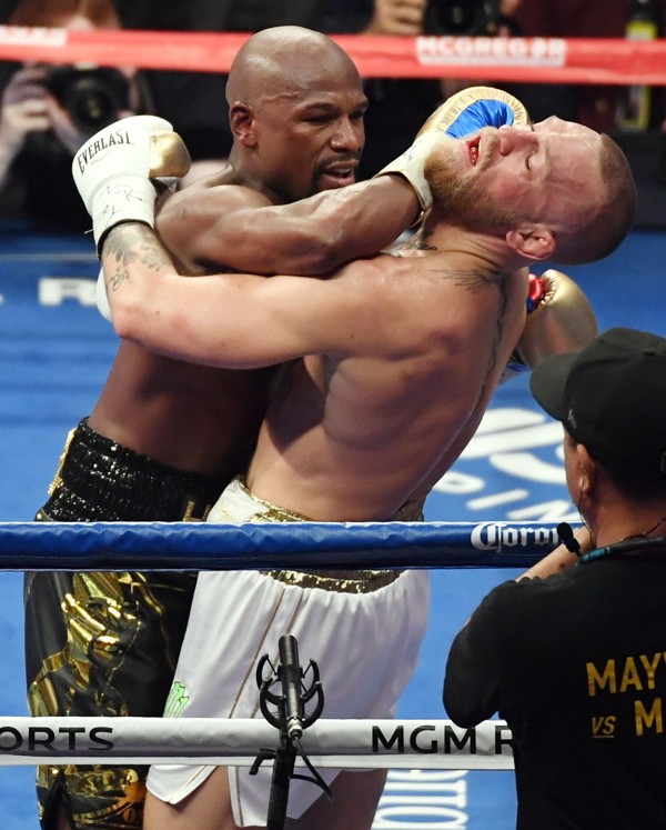 Mayweather treats McGregor to some of the rough stuff during their Las Vegas bout. Photo: AFP