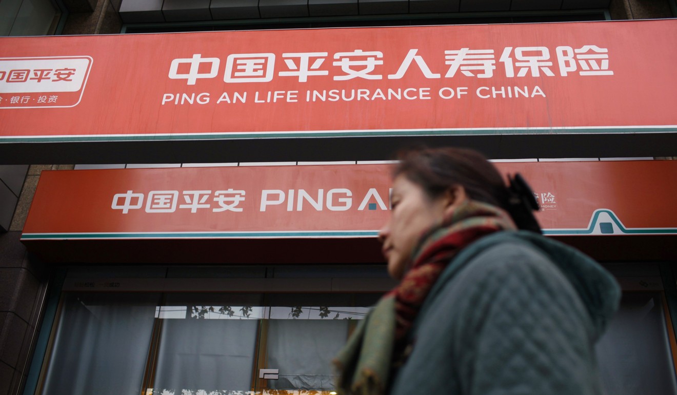 A woman walks past a Ping An Insurance outlet in Shanghai. Photo: Reuters