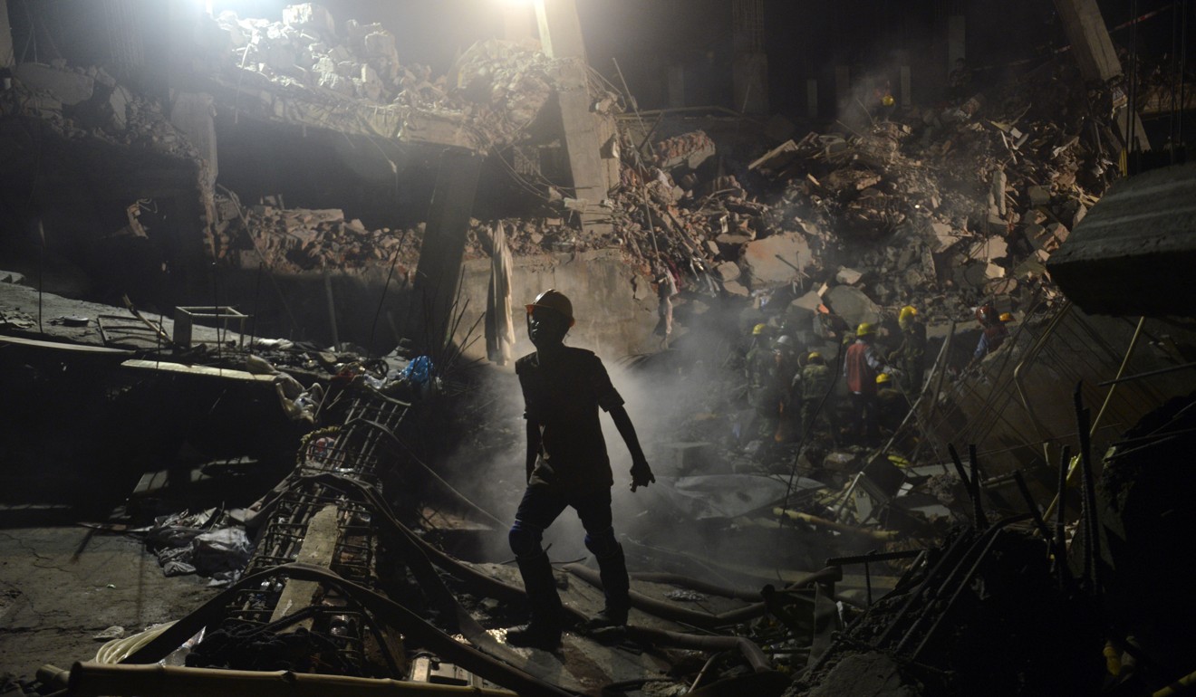 A worker leaves the site where a garment factory building collapsed. Photo: AP
