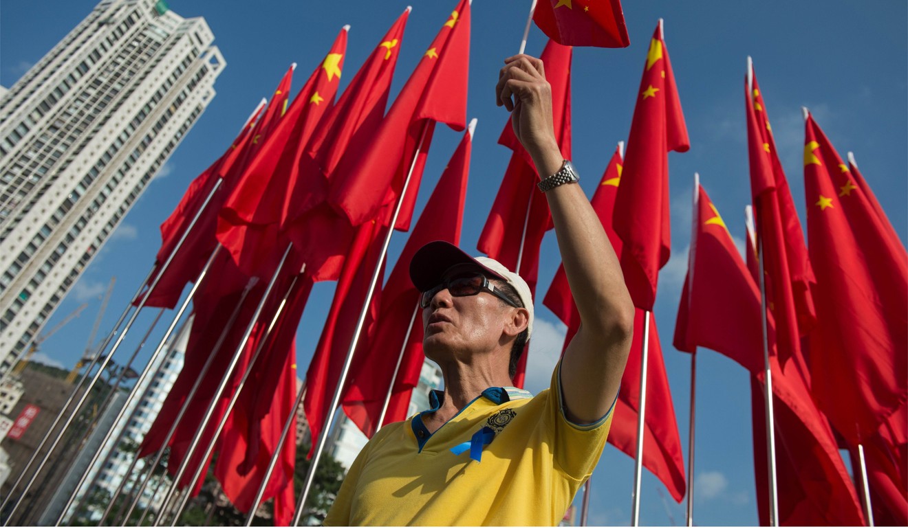 A Hong Kong man sings the national anthem to celebrate the 65th anniversary of the founding of communist China at Victoria Park in 2014. Photo: AFP