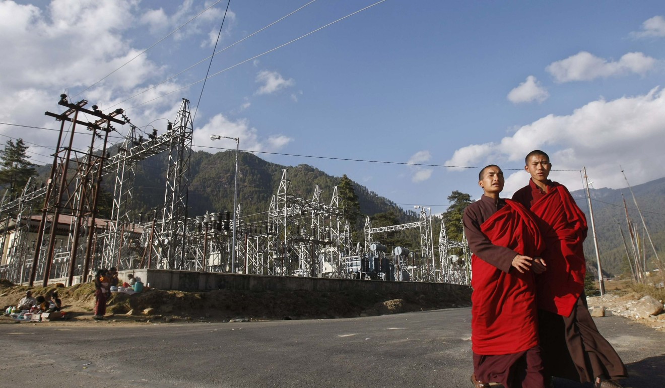 Buddhist monks walk past a power station in Thimphu in November 2009. Photo: Reuters