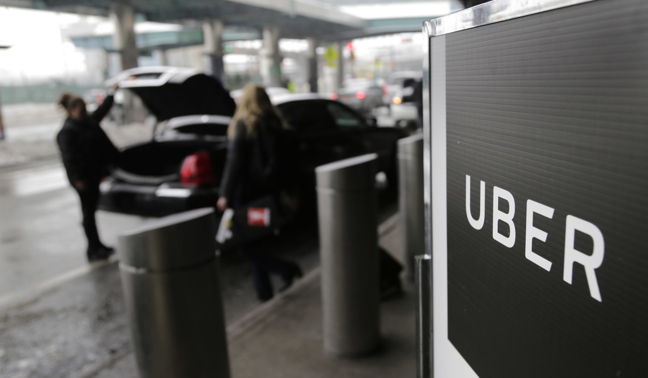 A sign marks a pick-up point for the Uber car service at LaGuardia Airport in New York. In New York City, the price of a taxi licence was around US$1.3 million in 2013, but fell to some US$500,000 in 2016 as a result of ride-sharing apps like Uber and Lyft entering the market. Photo: AP