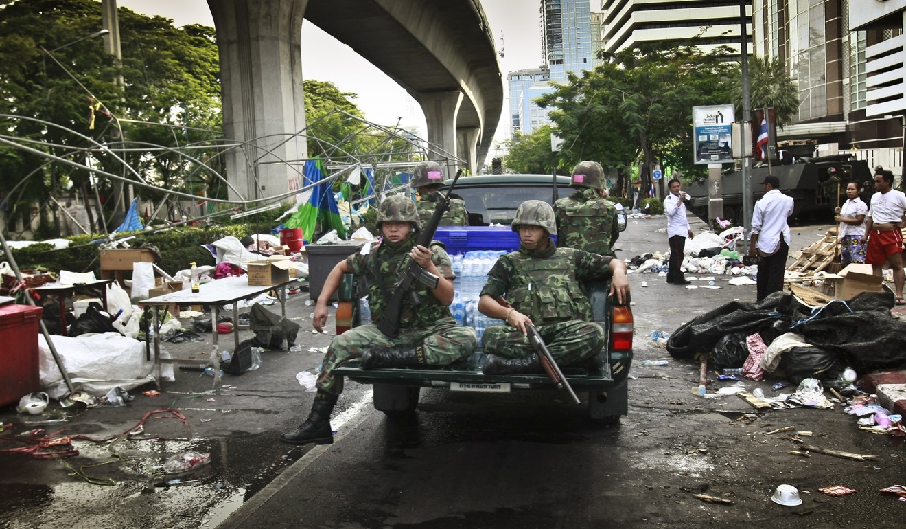 Thai soldiers ride through an area formerly held by anti-government protestors in May, 2010. Photo: AP