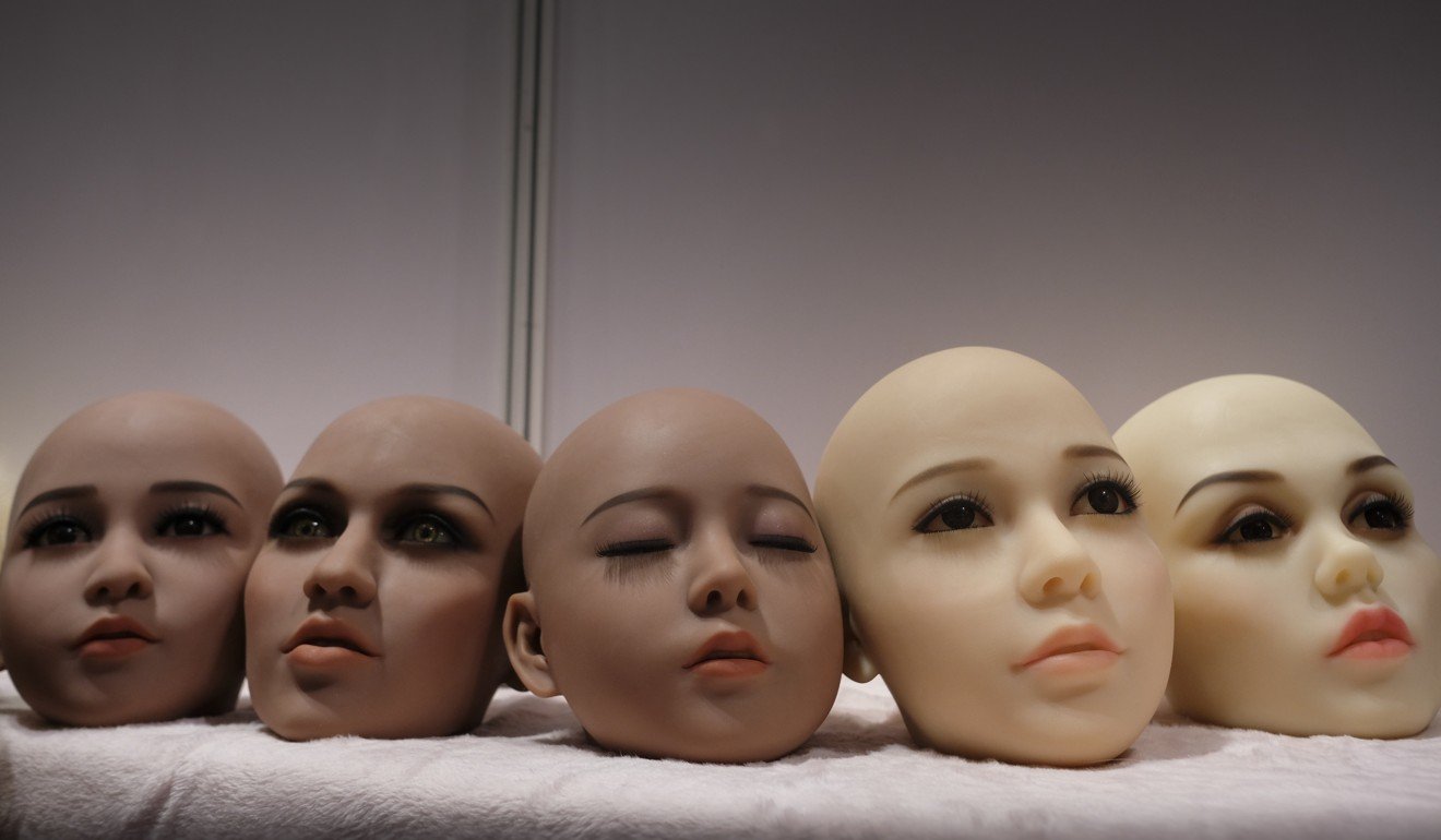 Customisable sex doll heads on display at a booth. Photo: James Wendlinger