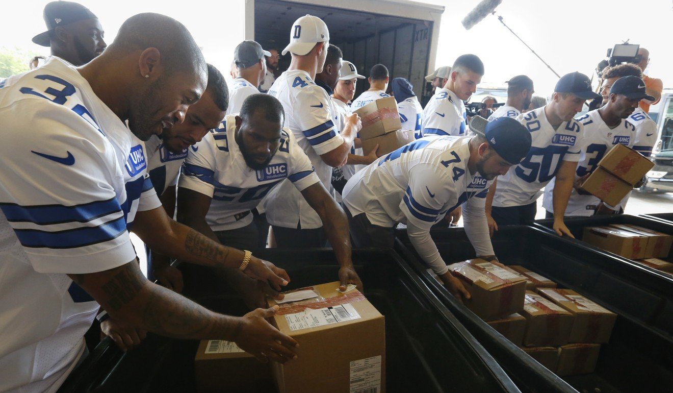 Dallas Cowboys players unload about 300,000 pieces of donated clothes at The Salvation Army Adult Rehabilitation Centre in North Texas. Photo: AP