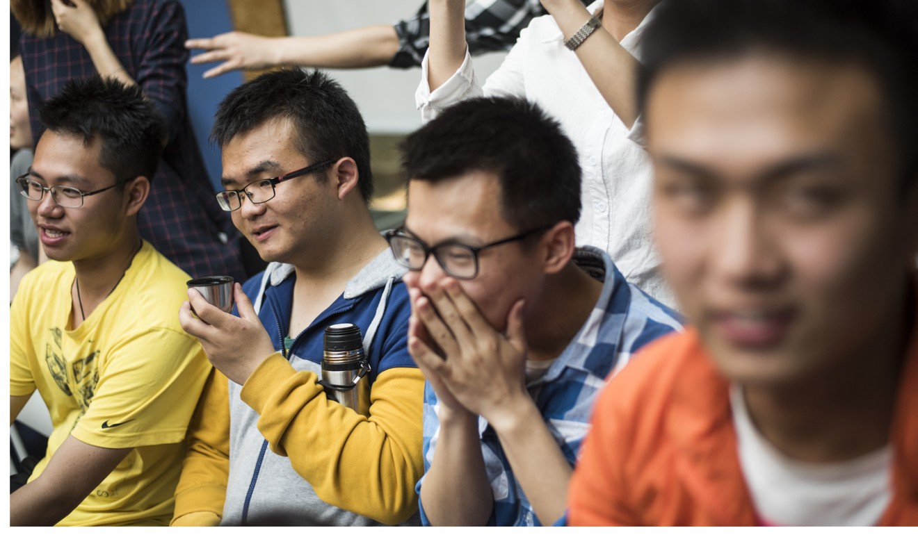 Chinese students laugh during a course about romantic relations. Photo: AFP