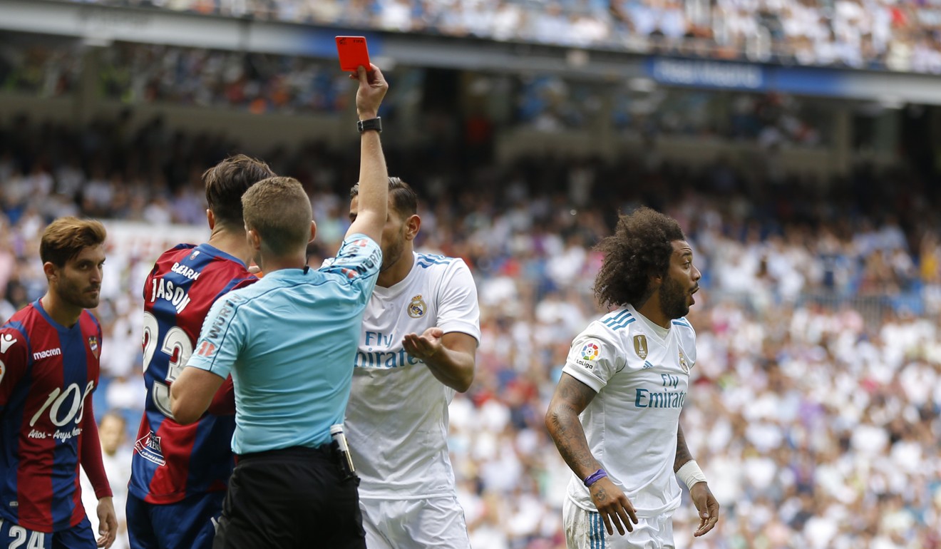 Real Madrid’s Marcelo (right) is shown a red card. Photo: AP