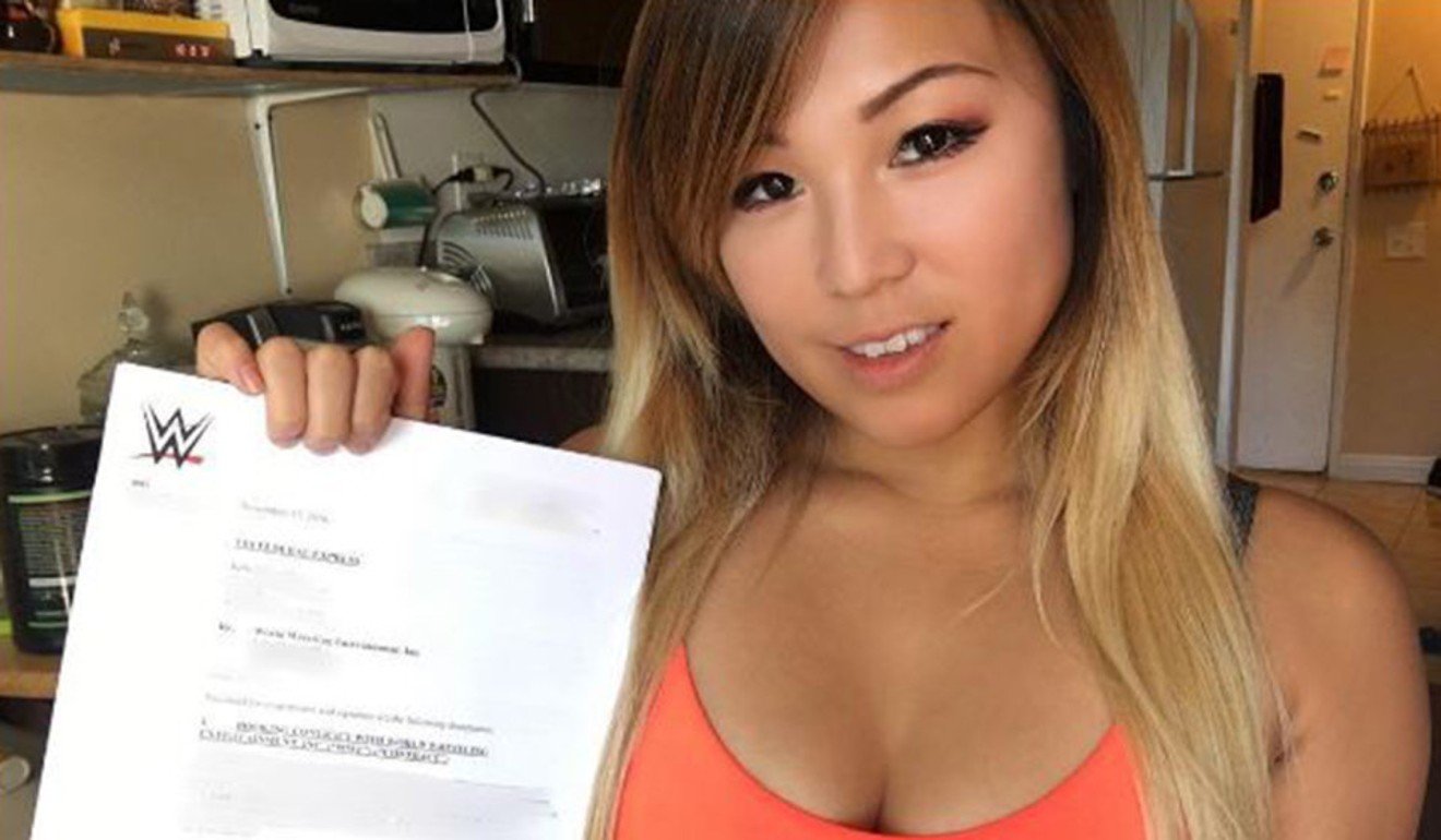 Julia Ho shows off her WWE contract. Photo: Instagram/@zedawwe