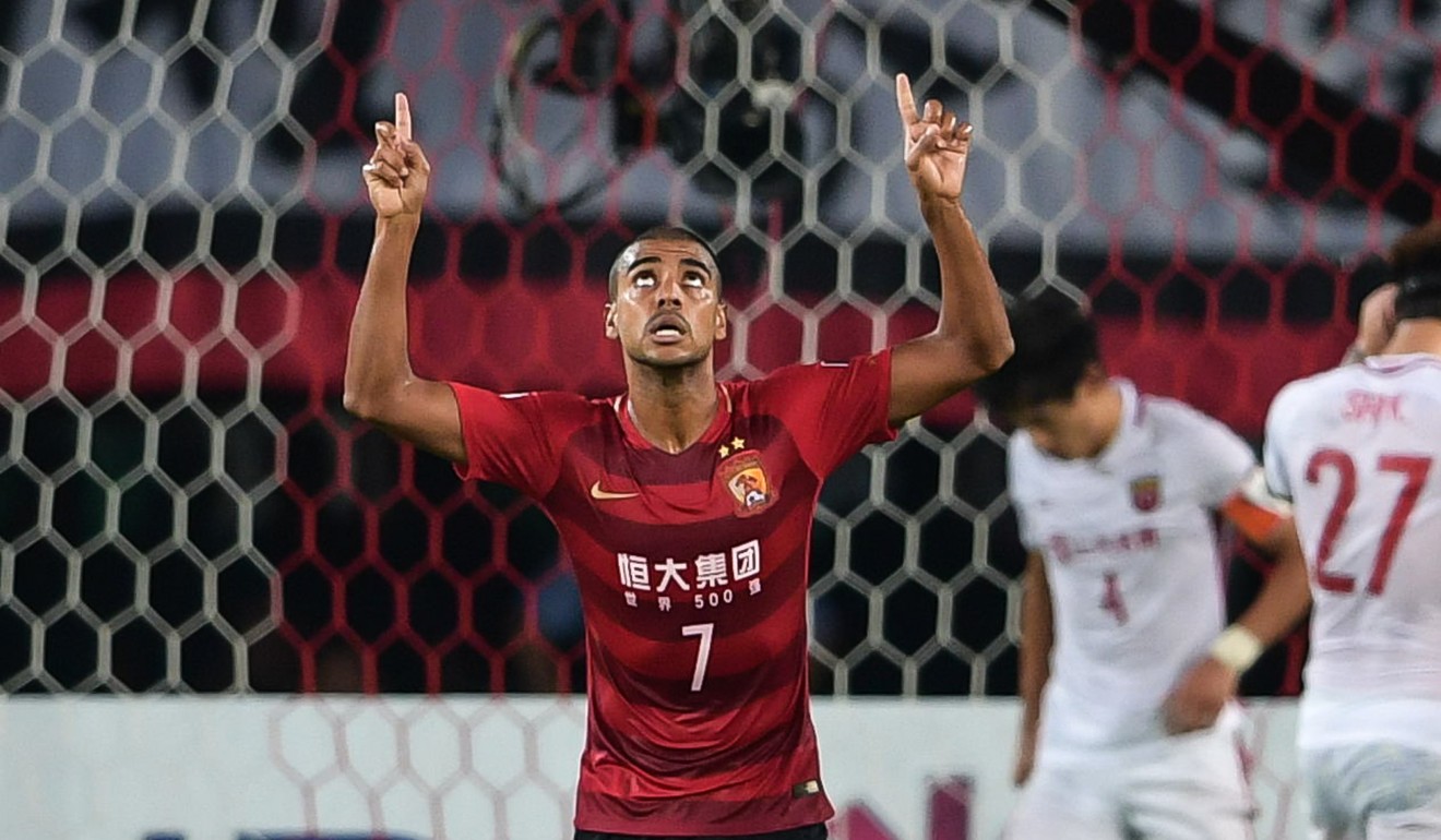 Alan celebrates scoring one of his two goals for Guangzhou Evergrande.