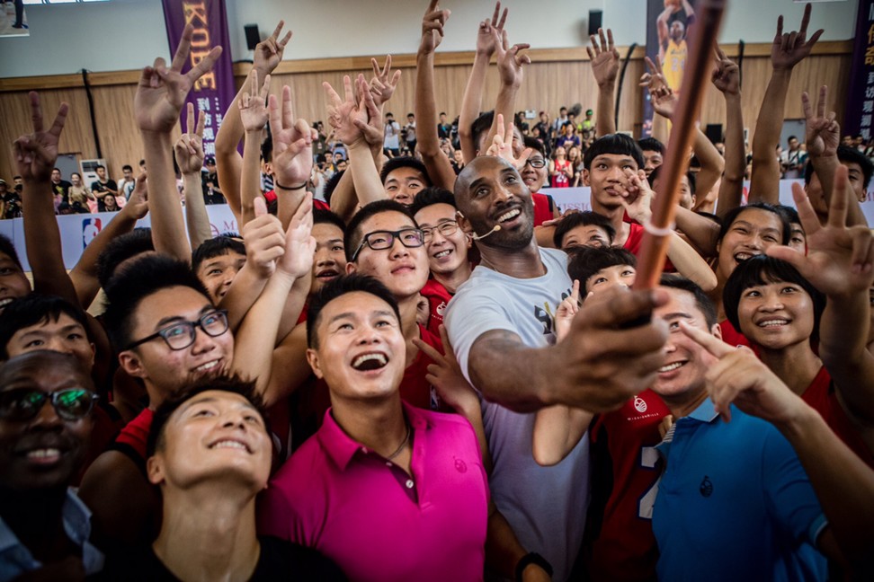 Bryant poses for a group selfie after a basketball clinic at the Overseas Chinese Mission Hills School. Photo: Mission Hills