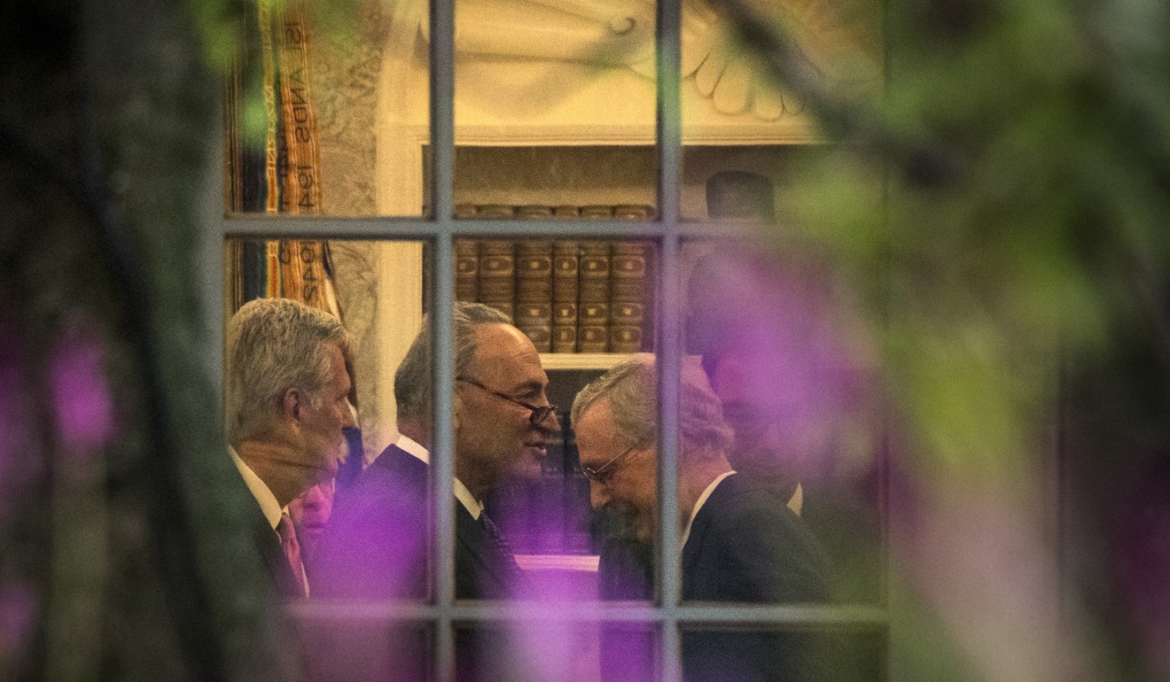 Senate Democratic Party Minority Leader Charles Schumer, centre left, and GOP Majority Leader Mitch McConnell are seen through a window of the Oval Office during a meeting with President Donald Trump, on September 6. Photo: Washington Post