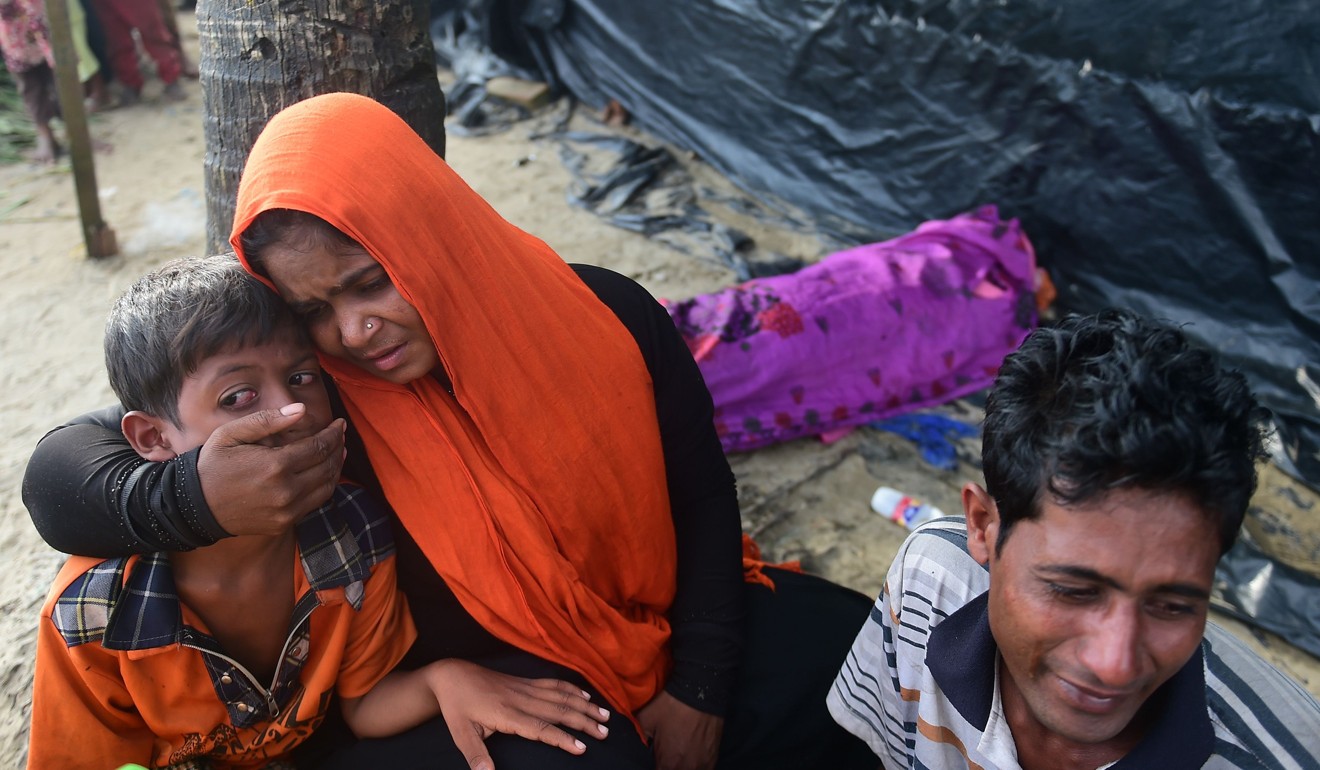 Rohingya refugees weep next to the body of a relative, who died when their boat capsized during their Naf river crossing, in the Bangladeshi city of Teknaf last Thursday. Bangladeshi boat operators are exploiting Rohingya Muslims fleeing violence in Myanmar by demanding up to US$100 for ferry trips that usually cost 50 US cents. Photo: AFP