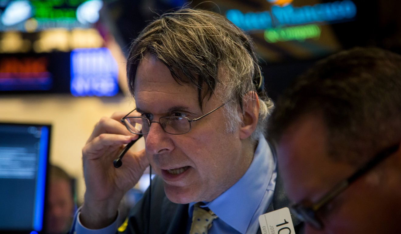 A trader gives his orders on the floor of the New York Stock Exchange as the US Federal Reserve announced it was keeping US interest rates flat and winding down its bond buying programme. Photo: Bloomberg