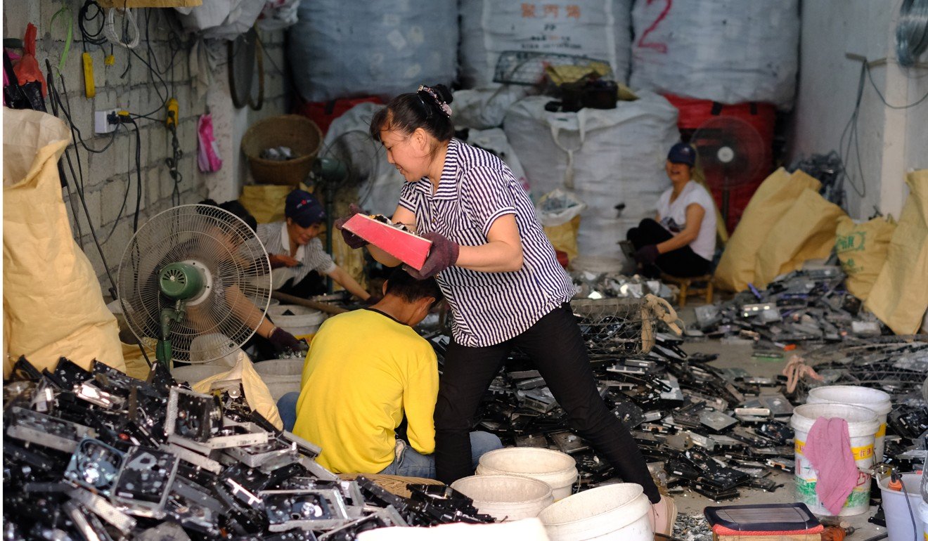 Workers dismantle electronic components at the Guiyu Recycling Economy Industrial Park this month. Photo: Lea Li