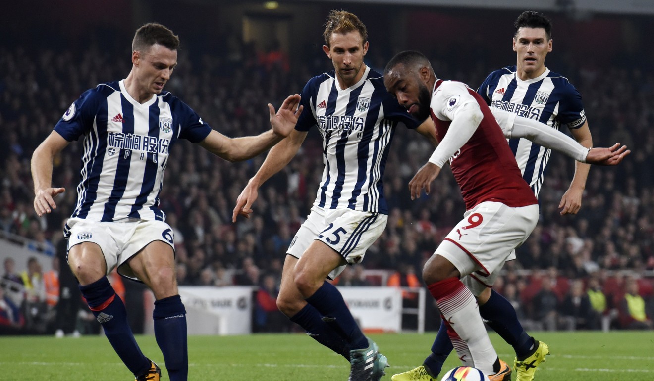 Alexandre Lacazette (2-R) vies for the ball with West Bromwich's Gareth Barry (R) Craig Dawson (C) and Jonny Evans (L). Photo: EPA