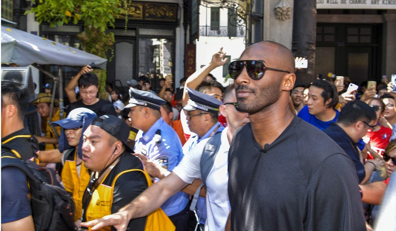 Bryant is mobbed by fans as he walks through a tourist hotspot in Haikou, China, in September. Photo: AFP