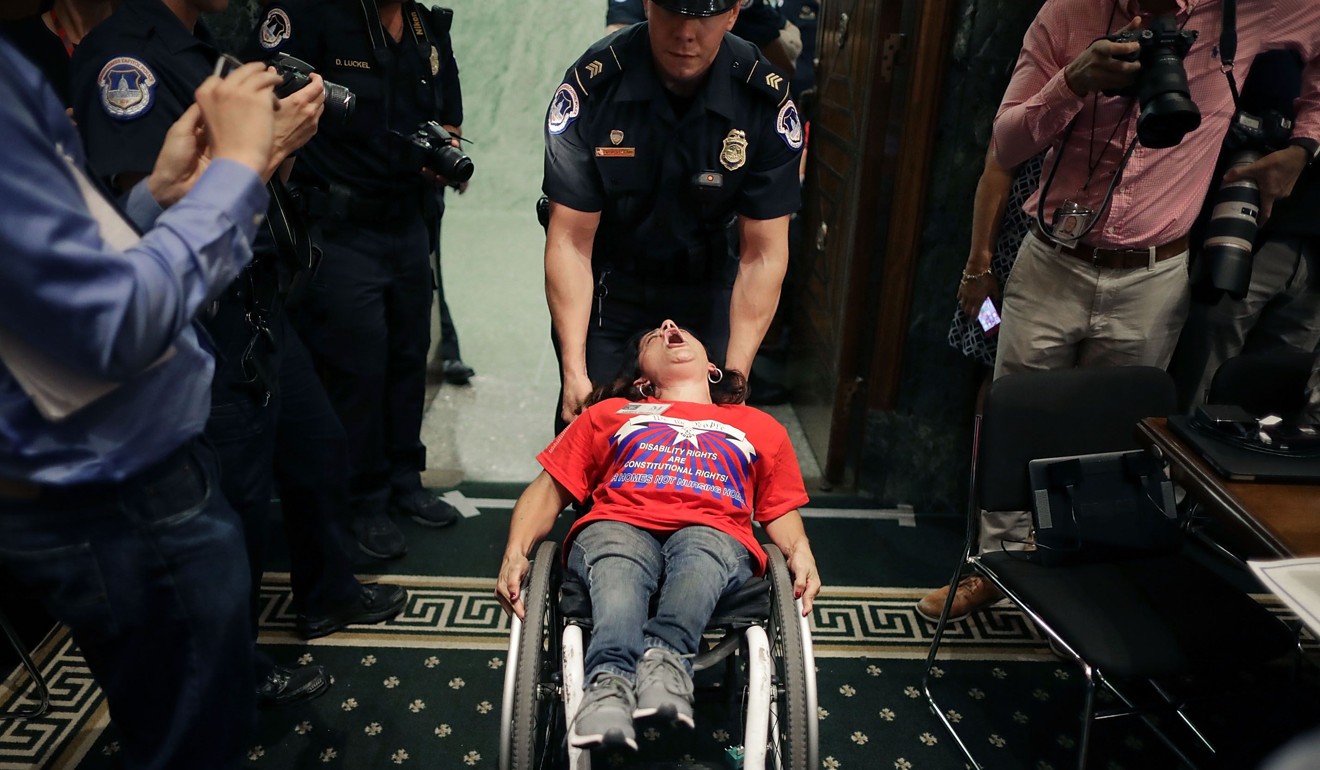 US Capitol Police remove a protester in a wheelchair from a Senate Finance Committee hearing about the proposed Graham-Cassidy health care bill, which has been withdrawn after failing to attract enough support among lawmakers. Photo: AFP