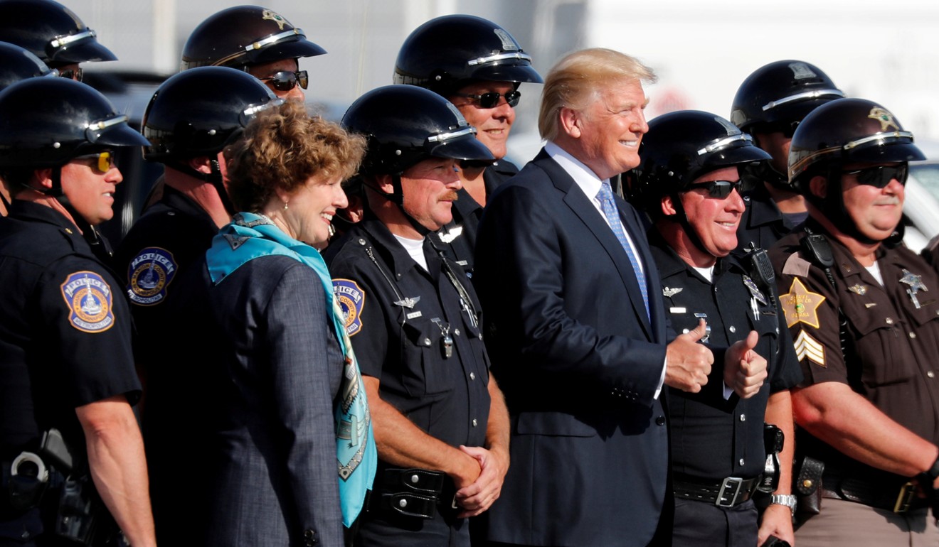 US President Donald Trump poses for a photo with motorcycle police officers at Indianapolis International Airport in Indiana on Wednesday. Photo: Reuters