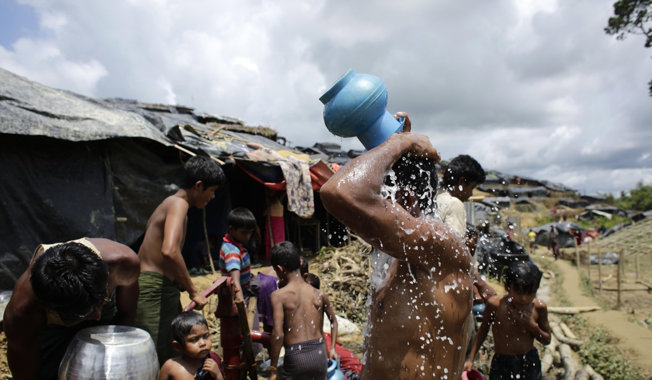 Rohingya refugees take baths in a camp in Cox's Bazar, Bangladesh. Photo: EPA