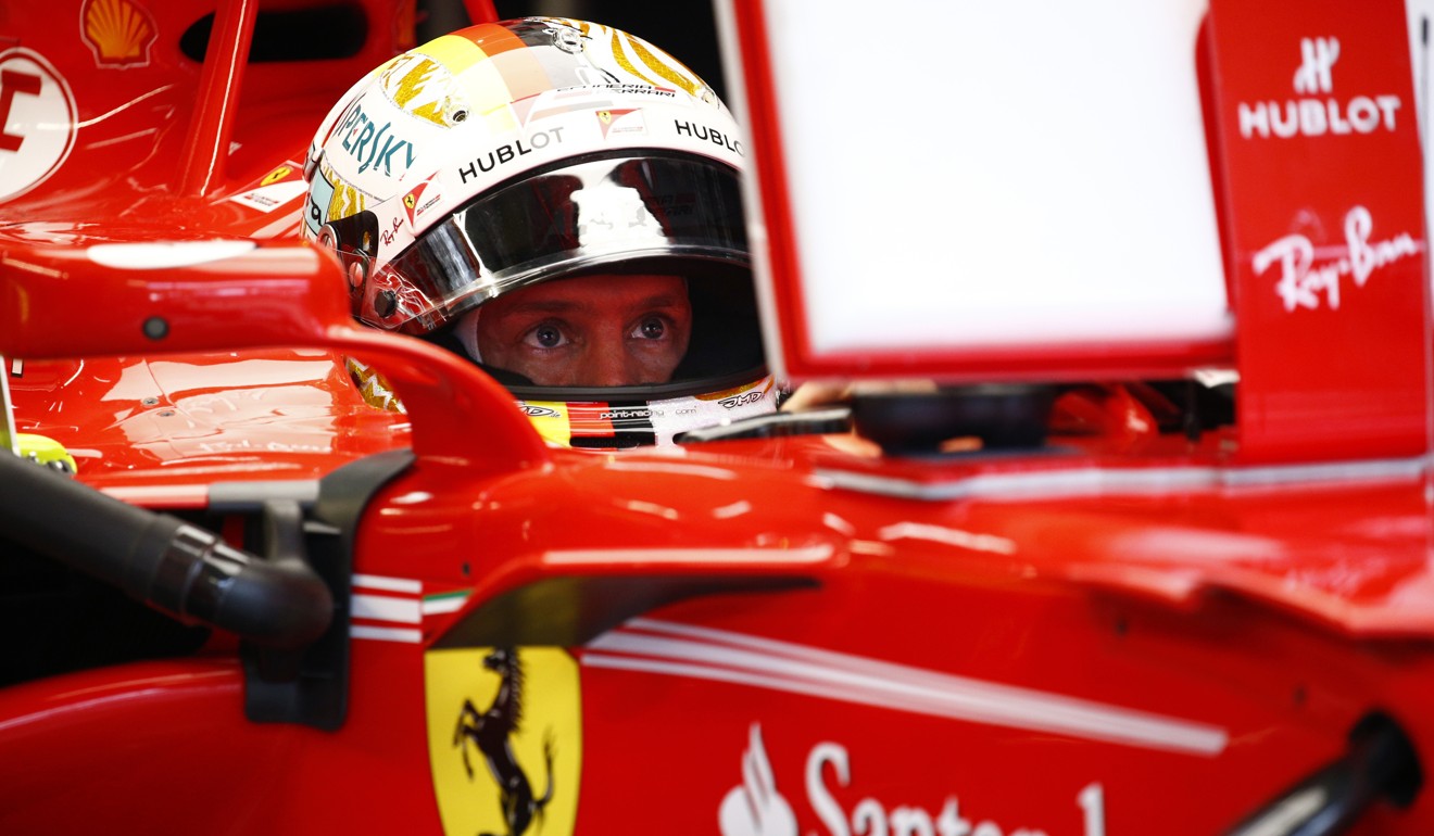 Ferrari driver Sebastian Vettel of Germany sits in his car before the third practice session. Photo: AP