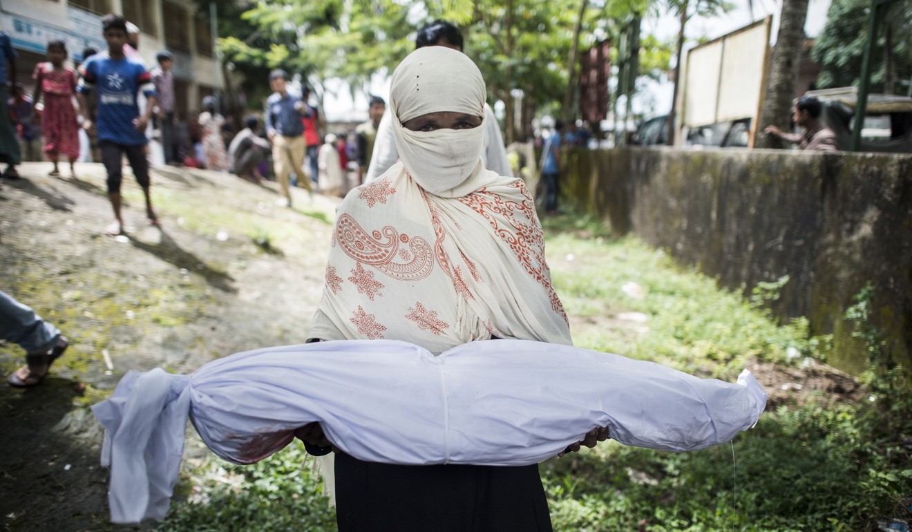 A Bangladeshi woman holds the body of a Rohingya Muslim refugee at a school near Inani beach in Cox's Bazar. Photo: AFP