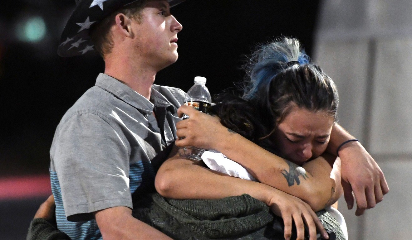 People hug and cry outside the Thomas&Mack Centre after the mass shooting. Photo: AFP