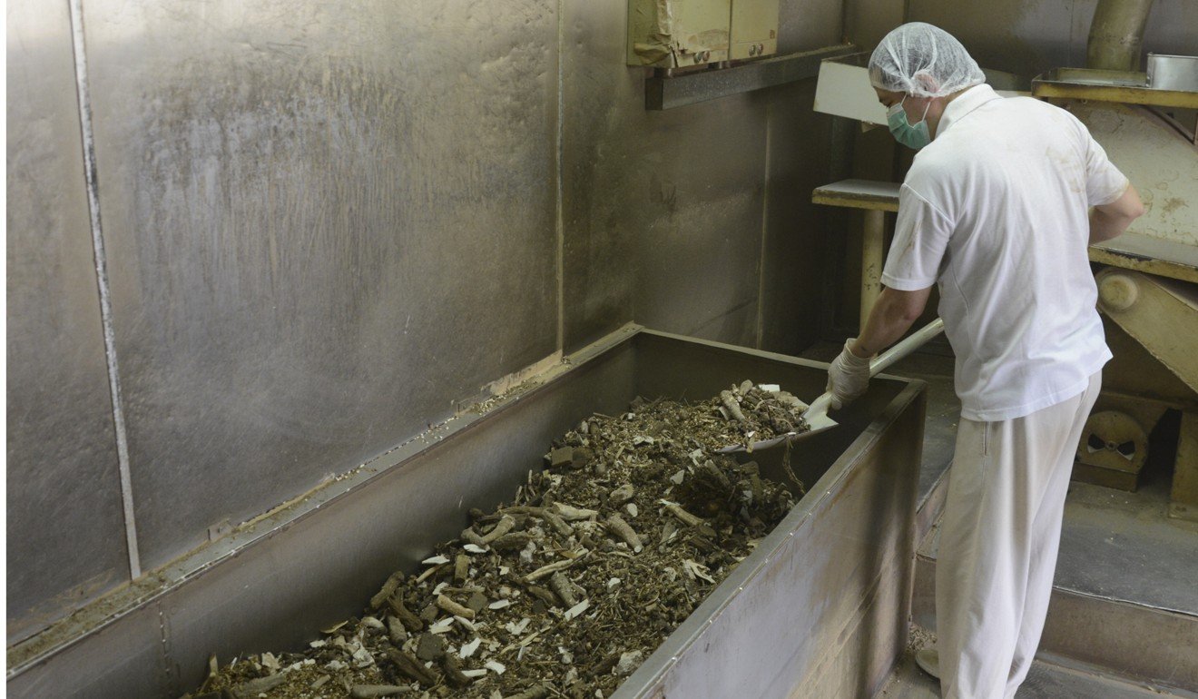A worker sifts through chopped up Chinese herbs on the production line at Po Chai Pills old factory in North Point. Photo: Po Chai Pills