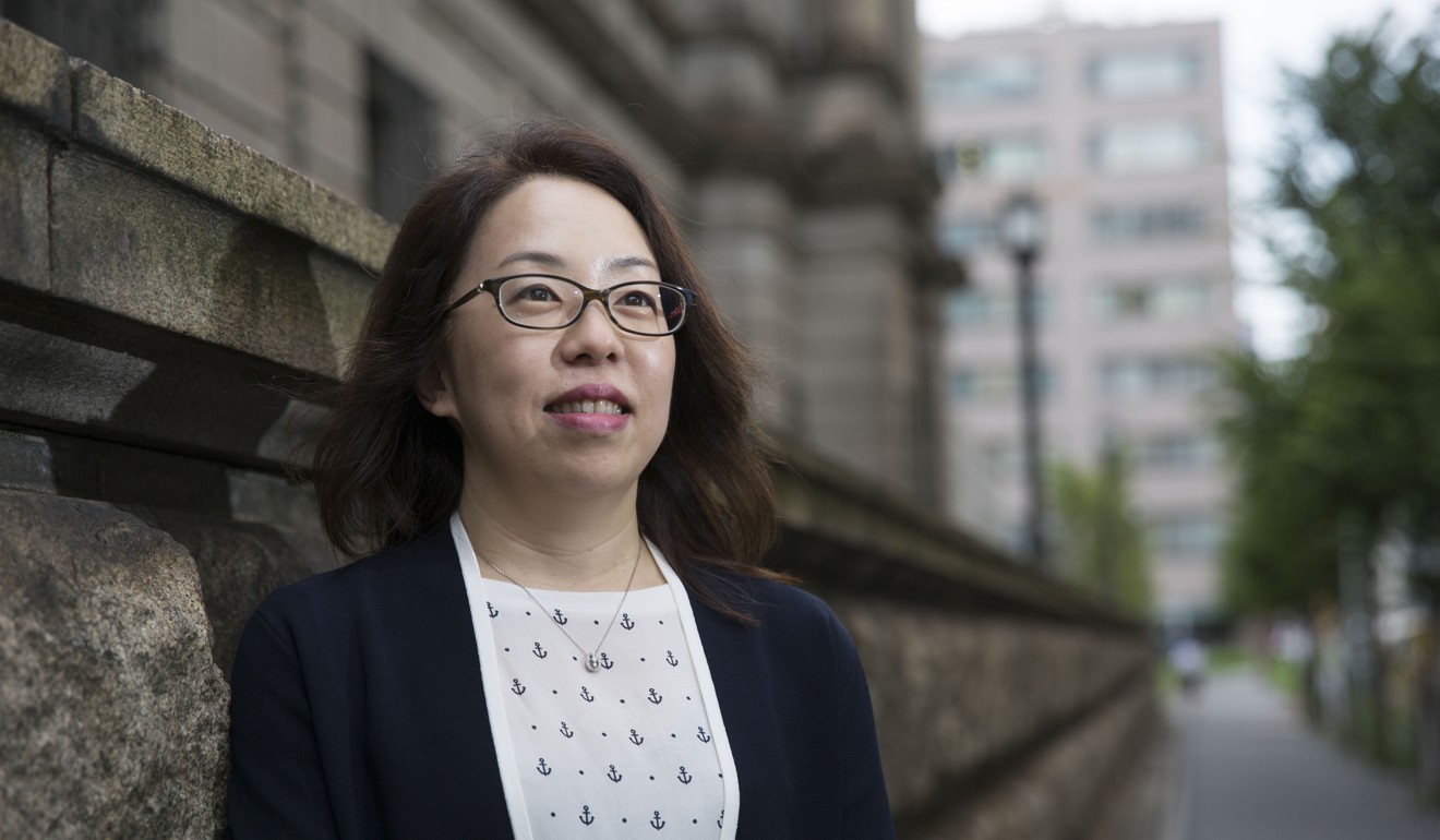 Risa Ueda, head of the commercial banks examination-planning division at the Bank of Japan, is seen outside the BOJ headquarters in Tokyo on September 13. The BOJ has sought to hire and promote more women in career-track positions, but women’s overall participation in the economy is considerably lower than men’s. Photo: Bloomberg